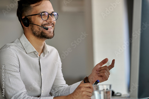 Canvas Print Happy customer service representative working on desktop PC at call center