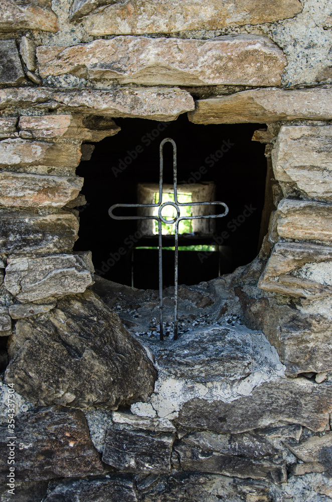 Iron cross in a rock wall