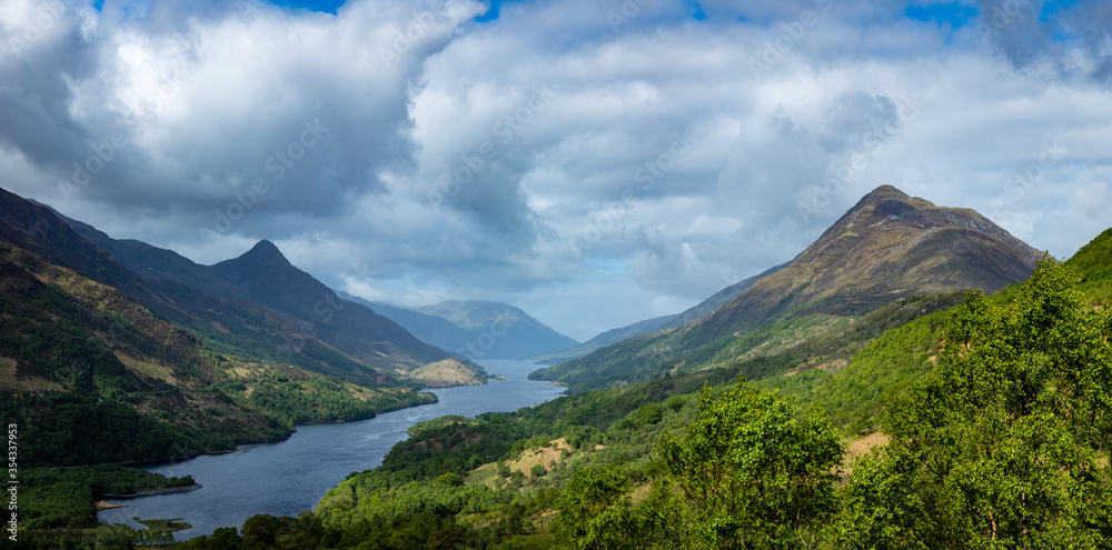 a view over loch leven from the west highland way near kinlochleven and fort william in the argyll region of the highlands of scotland during a warm spring day showing green forest and hillsides