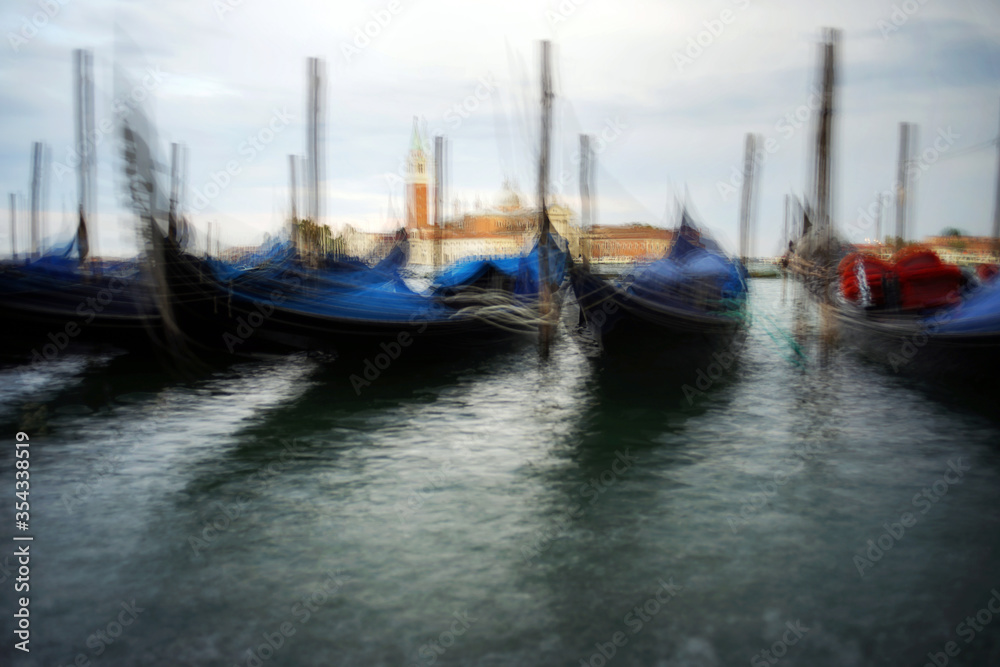 Venice, Italy - August 25, 2018. Gondolas at the pier overlooking the San Giorgio Maggiore. Gondolas at the pier in Venice. Venice, Italy - August 25, 2018. Gondolas at the pier overlooking the San Giorgio Maggiore. Gondolas at the pier in Venice.