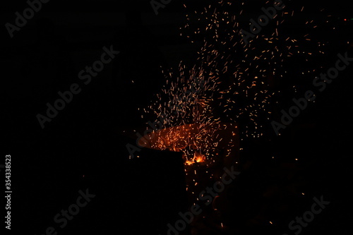 Amazing Sparks in the Dark. Beautiful abstract background on the theme of fire  light and life. Sparks fly in the sky