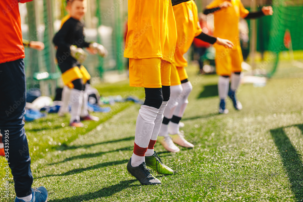Children Jumping on Soccer Sports Training. Kids Running on Warm-up Before the Soccer Game. Coach with Youth Team on Tournament Match Children Jumping on Soccer Sports Training. Kids Running on Warm-up Before the Soccer Game. Coach with Youth Team on Tournament Match