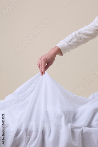 hand pulling white fabric