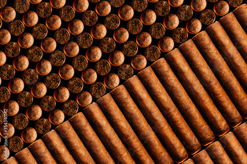 A vertical look of fresh hand-cooked new cigars.concept of a businessman's rich leisure