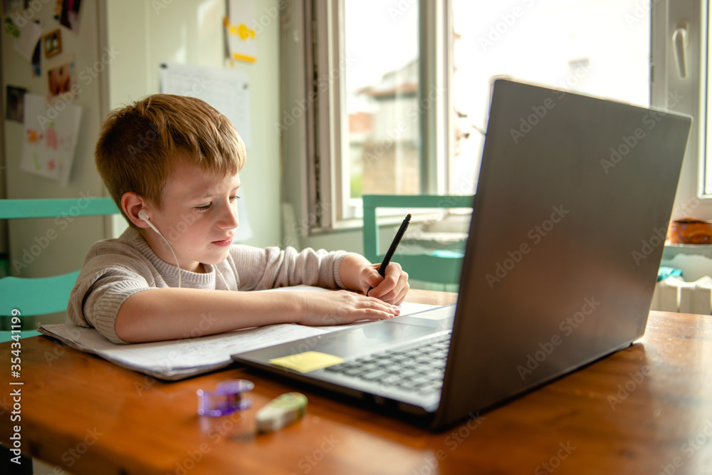 Young boy learning at home during quarantine