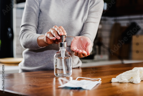 Closeup of woman hands using hand sanitizer liquid for bacteria and virus neutralization. Keep your hands germ-free and virus free with the use of hand sanitizer. Personal Protective Equipment for Inf