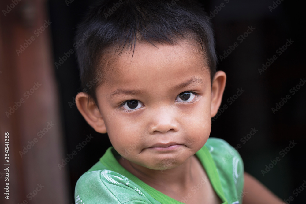 Portrait of face boy smiling on black background, close-up Portrait of face boy smiling on black background, close-up