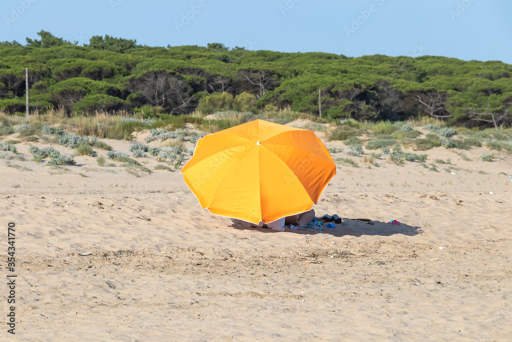 Orange beach umbrella on the beach