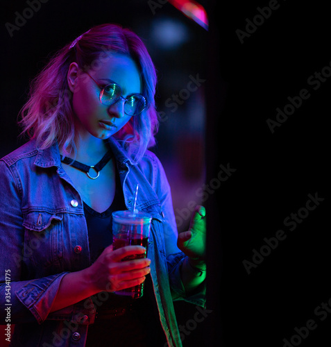 Young woman under the colorful neon lights.
