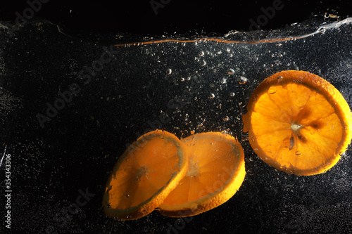 Water drops on ripe sweet orange. Fresh mandarin background with copy space for your text. Vegetarian concept.