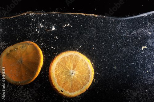 Water drops on ripe sweet orange. Fresh mandarin background with copy space for your text. Vegetarian concept. photo