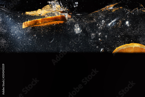 Water drops on ripe sweet orange. Fresh mandarin background with copy space for your text. Vegetarian concept.