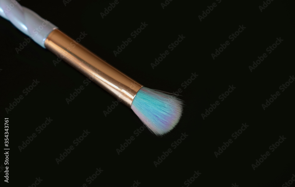 Fototapeta premium Colorful makeup brush on black background.Copy space