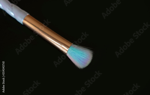 Colorful makeup brush on black background.Copy space