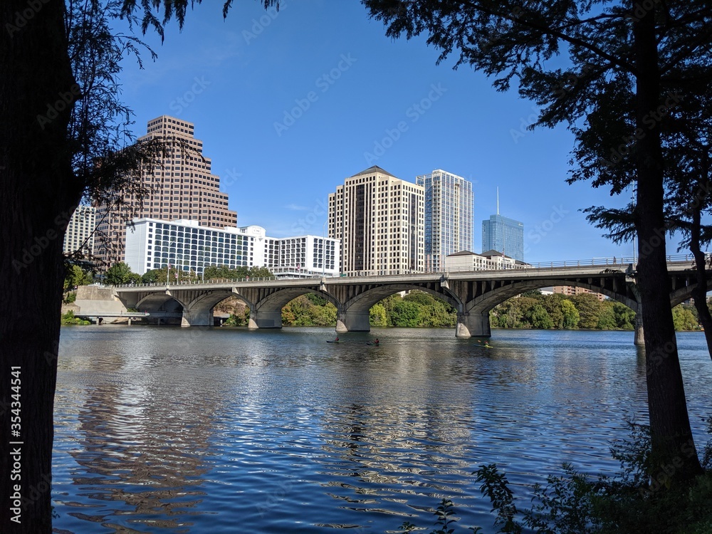 Austin TX bat bridge over river with buildings as back drop. Austin TX bat bridge over river with buildings as back drop.
