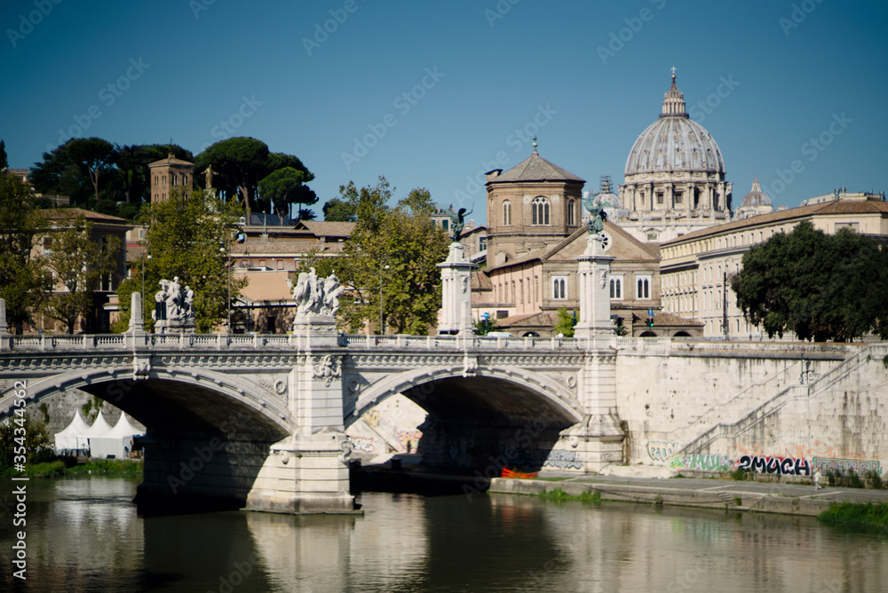 Rome skyline at day with Tiber river and St. Peter's Basilica. 