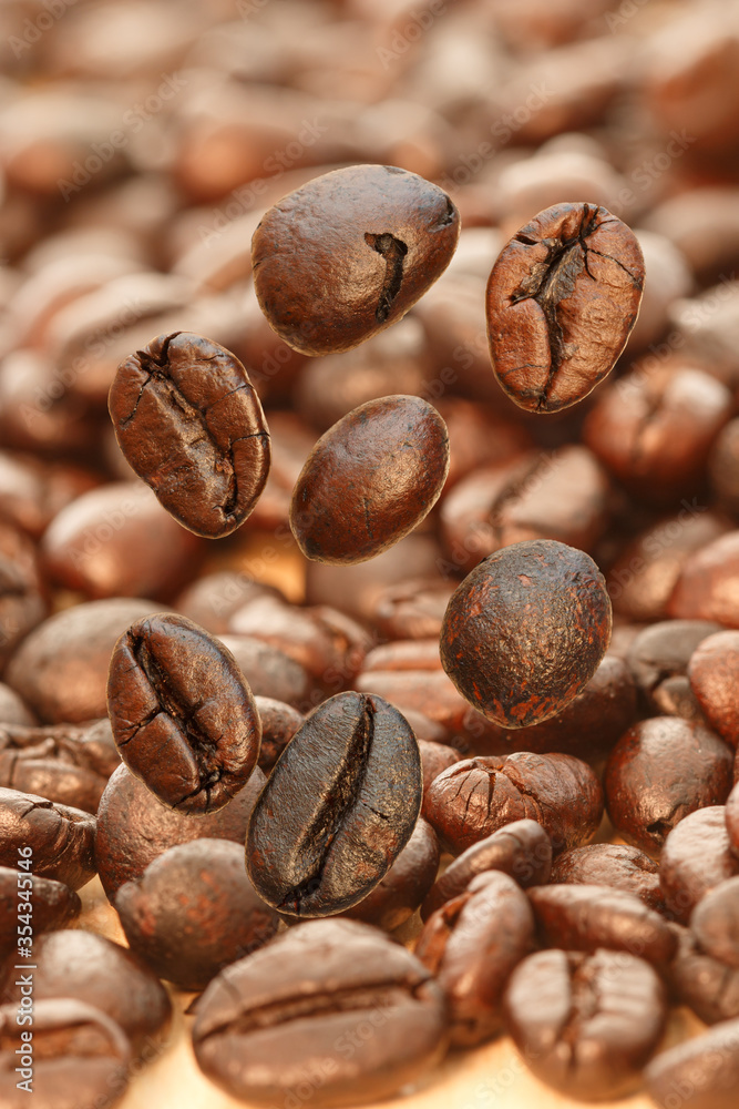 Fototapeta premium Dark roasted coffee beans falling on the wood floor