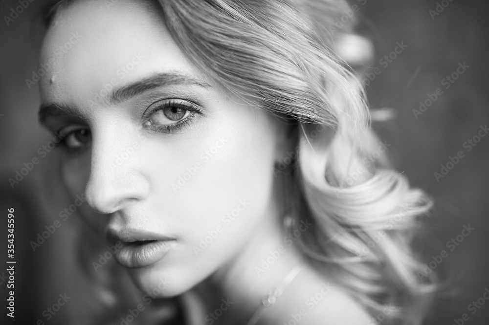 Fototapeta premium Monochrome portrait of serious sexy glamour woman wearing in elegant black lingerie. Woman looking in camera
