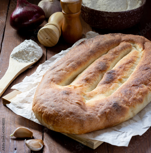 Armenian national bread matnakash and thin lavash on a wooden table