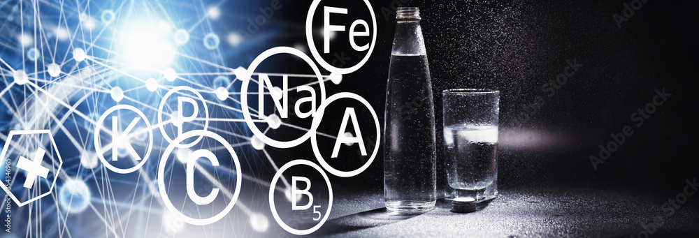 Obraz premium Close up pouring purified fresh drink water from the bottle on table in living room. Drinking water. Mineral vitamin water. Healthy, mineral-rich, refreshing water.