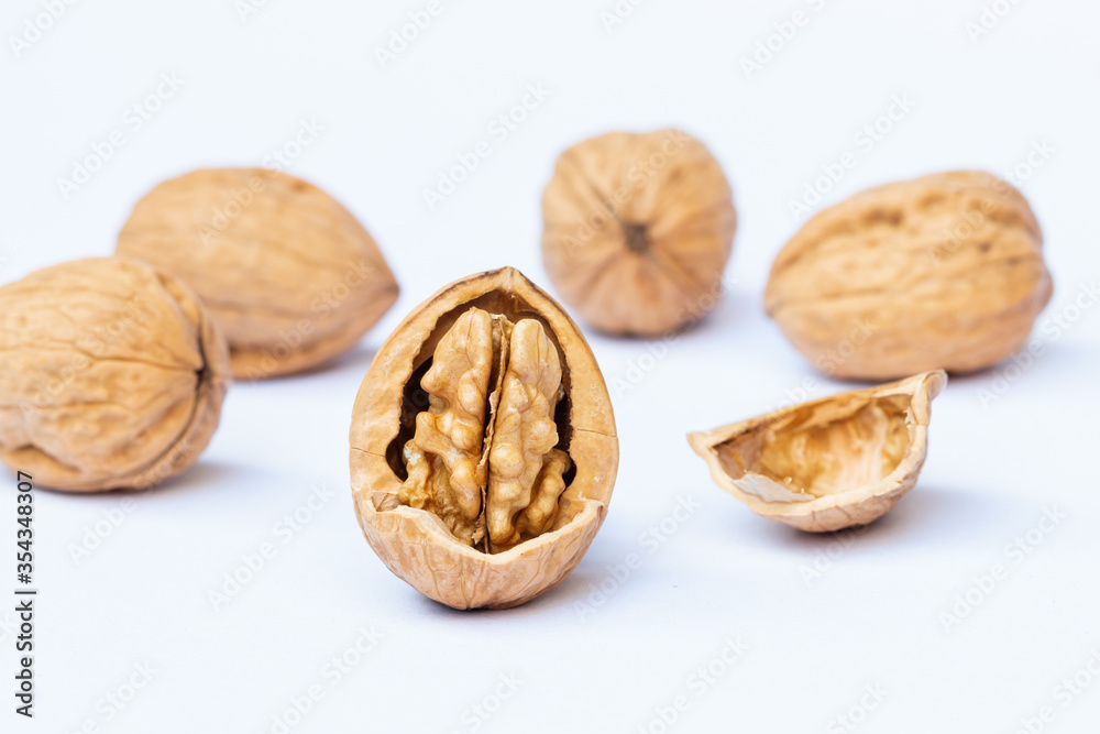 still life with Walnut kernels and whole walnuts on rustic table still life with Walnut kernels and whole walnuts on rustic table