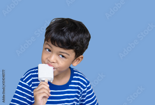 Little Thai boy eating white chocolate Ice cream