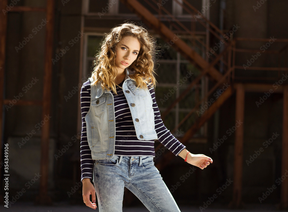 Portrait of young beautiful woman wearing jeans clothes outside at daylight Portrait of young beautiful woman wearing jeans clothes outside at daylight