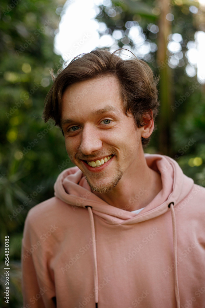 Portrait of young handsome happy man outside at nature at daylight Portrait of young handsome happy man outside at nature at daylight