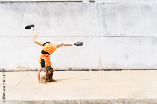 Teenage girl doing acrobatics outdoors