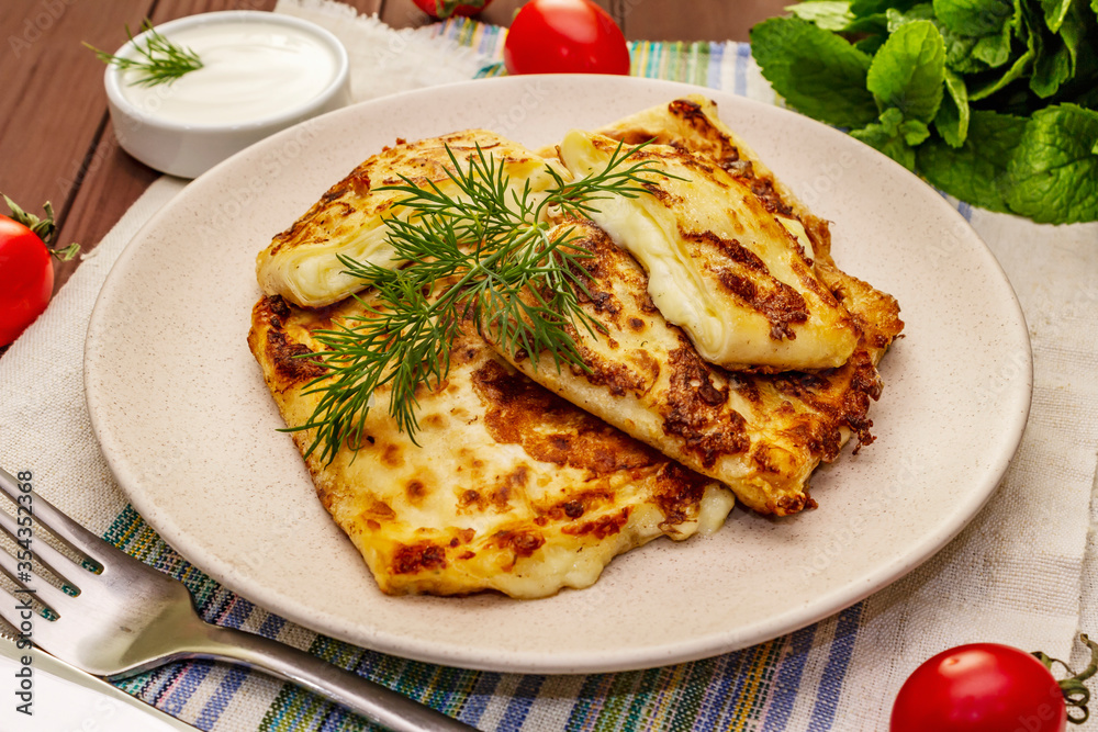 Hot appetizer - pita bread with cheese and herbs. Vegetarian healthy food Hot appetizer - pita bread with cheese and herbs. Vegetarian healthy food