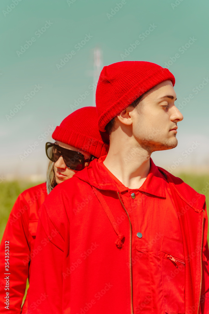Young couple with eyes closed dressed in red outdoors Young couple with eyes closed dressed in red outdoors
