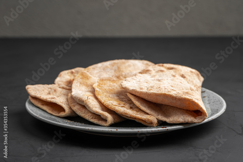 Flour tortillas with bran on a black background