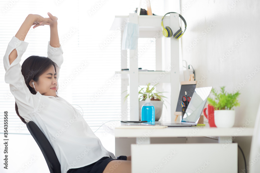 Asian women work at home according to government policies to prevent communicable diseases. She works hard and she is sleepy. Asian women work at home according to government policies to prevent communicable diseases. She works hard and she is sleepy.