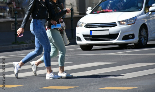 Women are walking on the pedestrian crossing