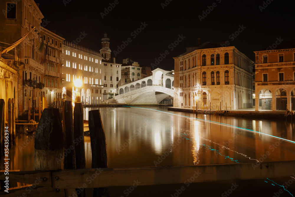Rialto Bridge Over Grand Canal Against Sky In City At Night. Venice, Italy.