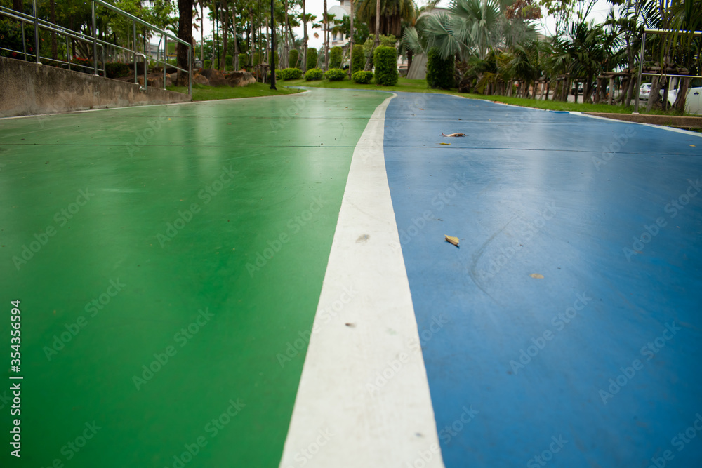 background of beautiful vivid color road walking path in the park on rainy day