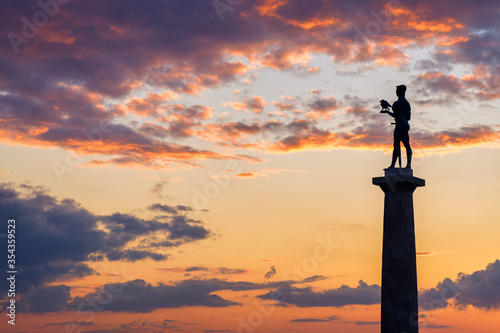 Silhouette of Victor monument with colorful sunset in the background  Belgrade