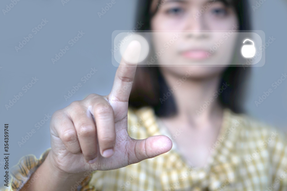 Asian women use their fingers to push the technology button. Asian women use their fingers to push the technology button.