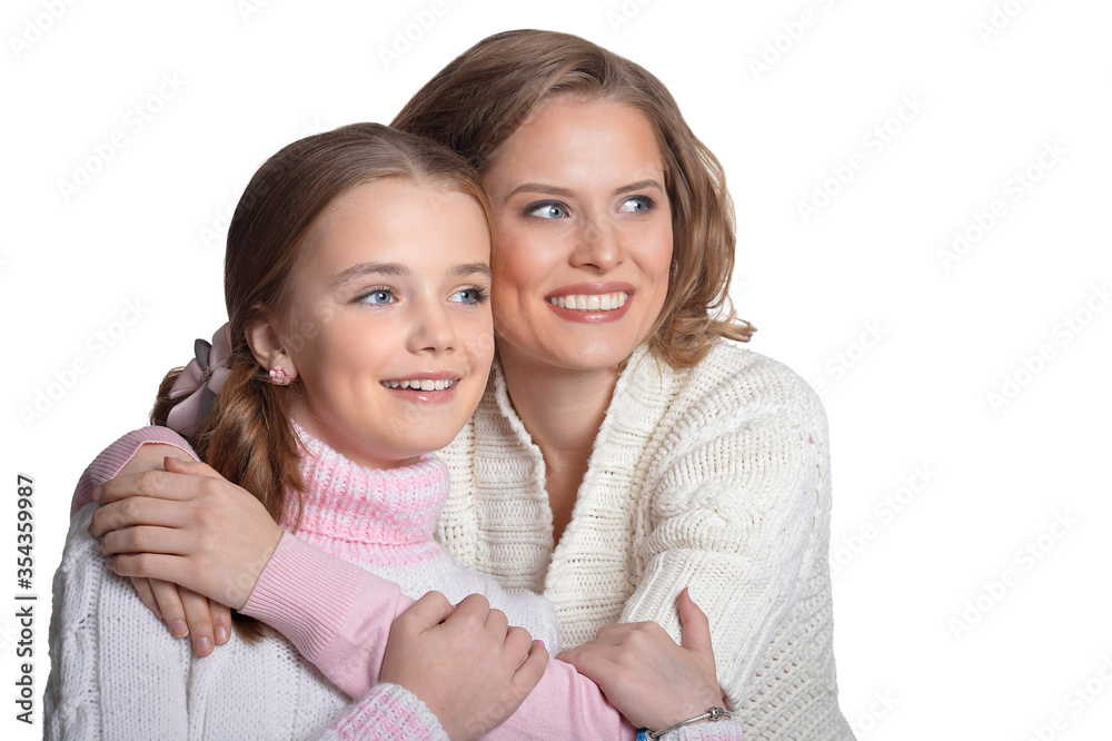 Beautiful mother hugs her daughter on a white background Beautiful mother hugs her daughter on a white background