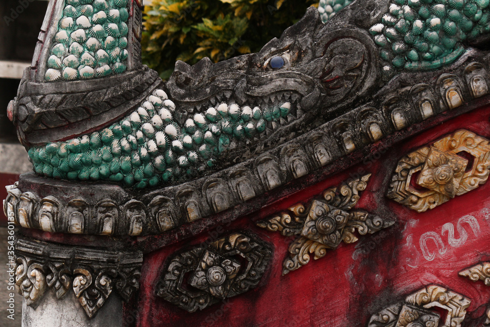 Detail of a stairway boundary  showing a dragon head in a temple in Siamese Lao PDR, Southeast Asia