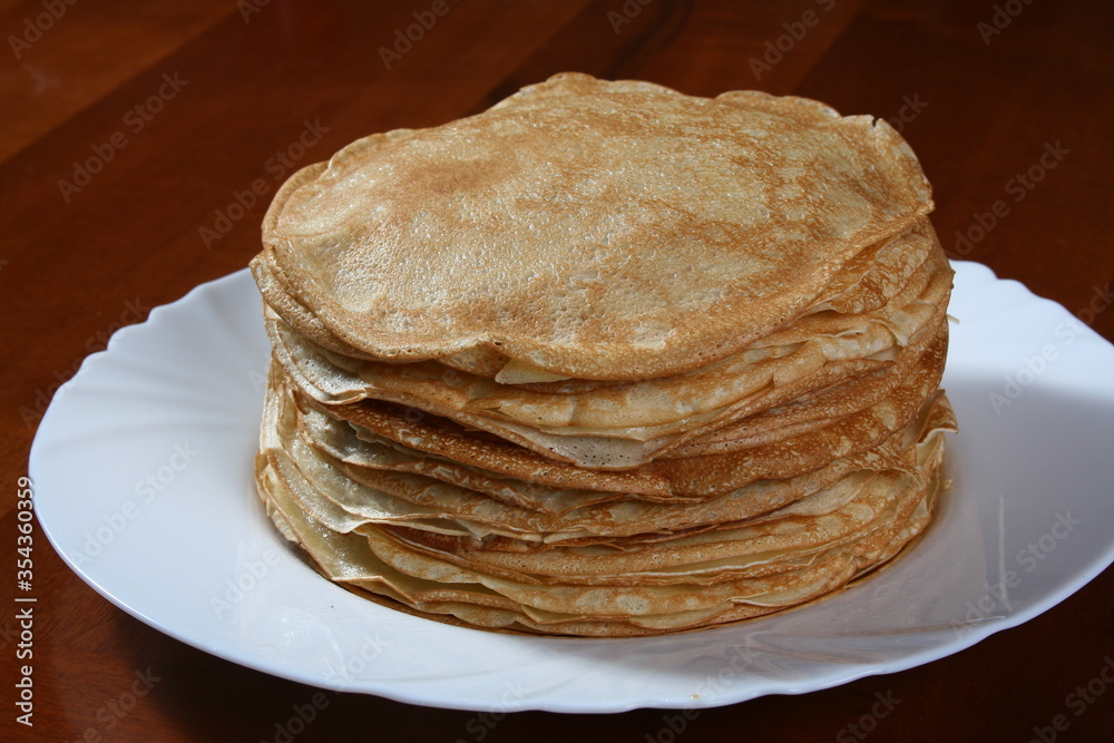 Thin pancakes on a white plate
