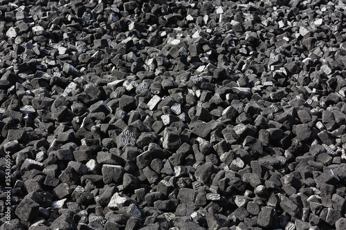 A scattering of gray slag on a sunny day. photo
