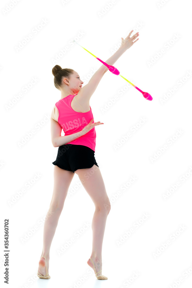 A girl gymnast performs exercises with a mace. A girl gymnast performs exercises with a mace.
