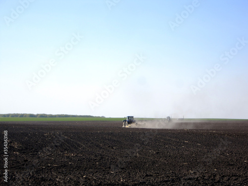 Wallpaper Mural Plowed field by tractor in brown soil on open countryside nature Torontodigital.ca