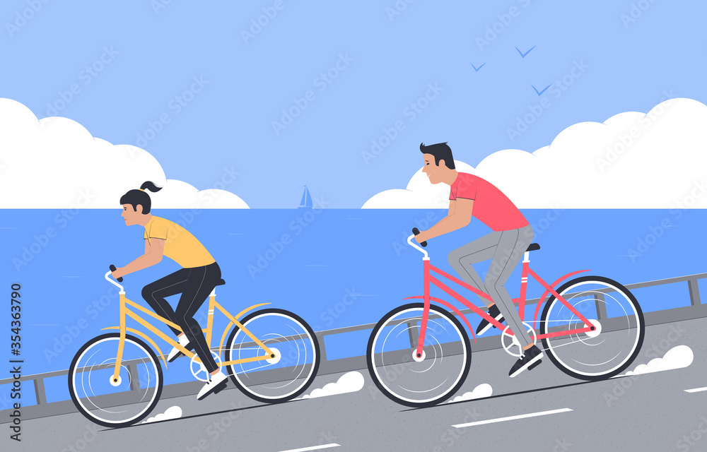 Fototapeta premium Bicycle walk. Outdoor sports, tourism. Happy couple rides bicycles on the background of the sea and clouds on the horizon