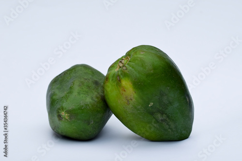 Two Green papaya, papaw or pawpaw or Raw papaya fruit Indian Mexico American 