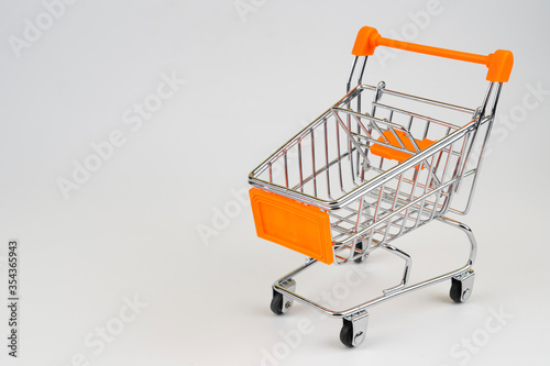 Empty supermarket trolley on a white background, shopping and world crisis