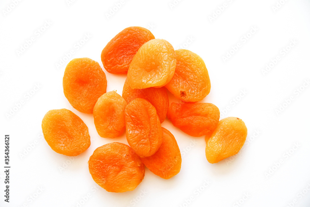 Pile of dried apricots on a white background. Top view.