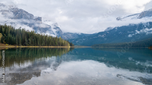 Beautiful alpine lake reflecting forest and surrounding mountains, shot at Emerald Lake, Yoho National Park, British Columbia, Canada