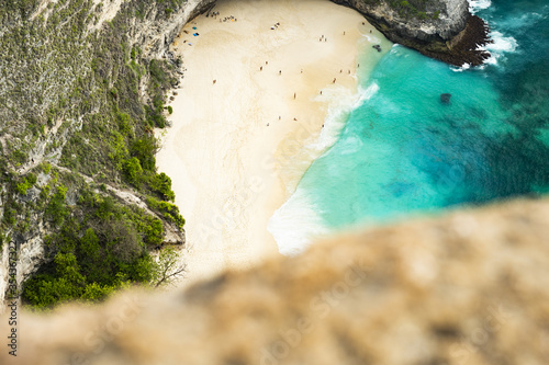 (Selective focus) View from above, stunning aerial view of a T-Rex shaped cliffs with the beautiful Kelingking Beach bathed by a turquoise sea. Nusa Penida, Indonesia.. photo